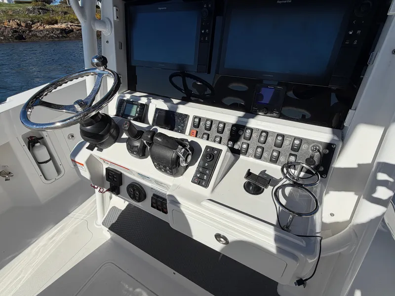 Slide: The Image of The image shows the helm of a 2016 Southport 33 FE boat with modern instruments. - 5