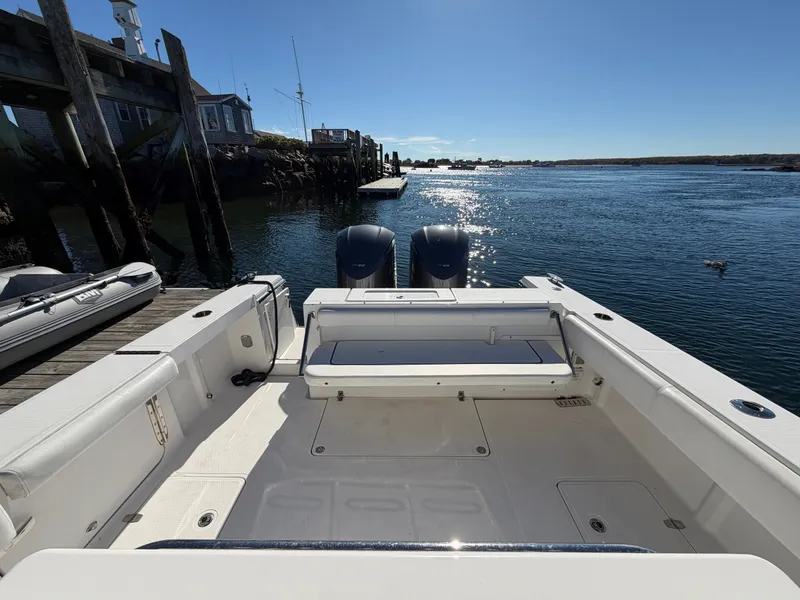 Slide: The Image of The image shows the stern of a 2016 Southport 33 FE boat at a dock. - 21