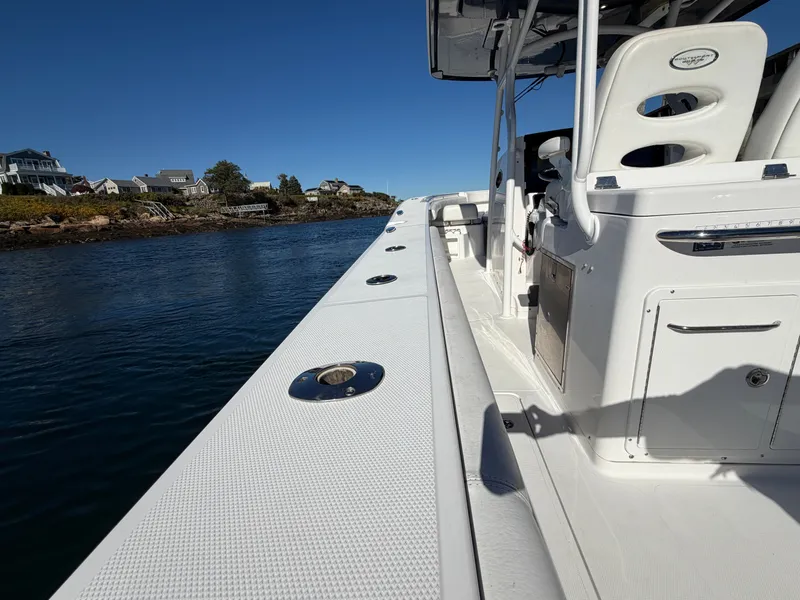Slide: The Image of The image shows the deck of a 2016 Southport 33 FE boat on calm water. - 4