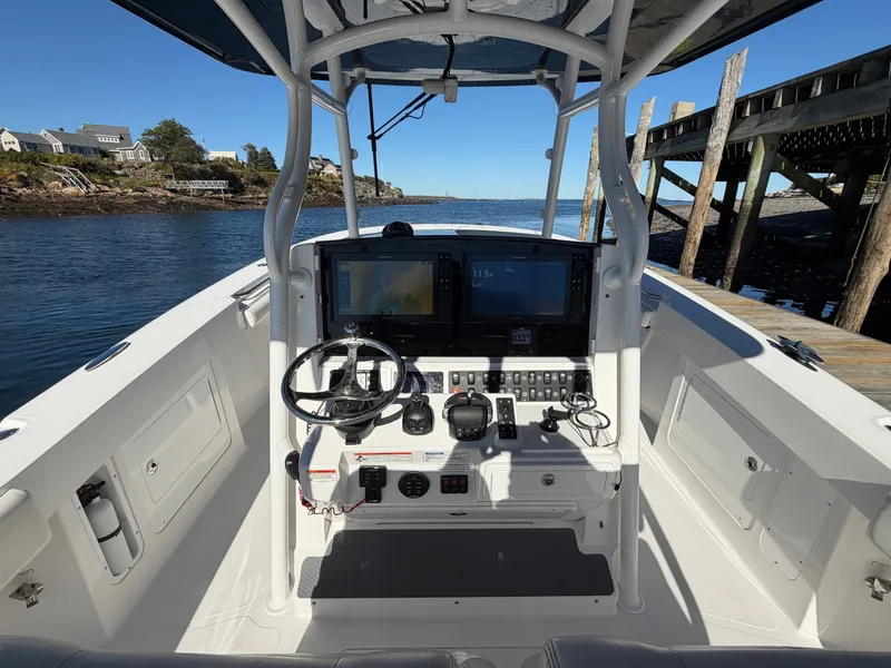Slide: The Image of The cockpit of a 2016 Southport 33 FE boat with modern electronics and controls. - 14