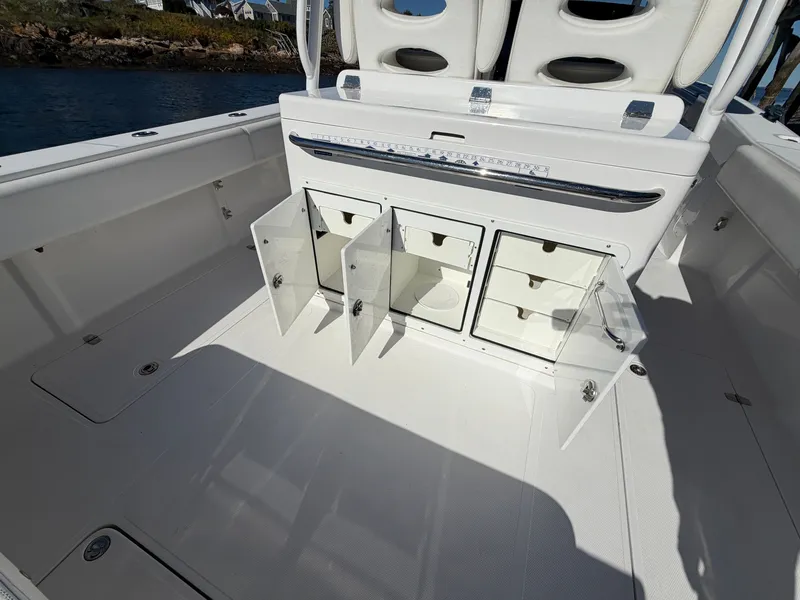 Slide: The Image of Open storage area with drawers and doors on a boat, surrounded by white deck. - 16