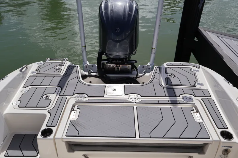 Slide: The Image of 2023 NauticStar 251 Hybrid boat stern with outboard motor and sleek deck design. - 21