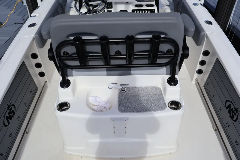 Slide: The Image of 2023 NauticStar 251 Hybrid boat interior with rod holders and sink station. - 27