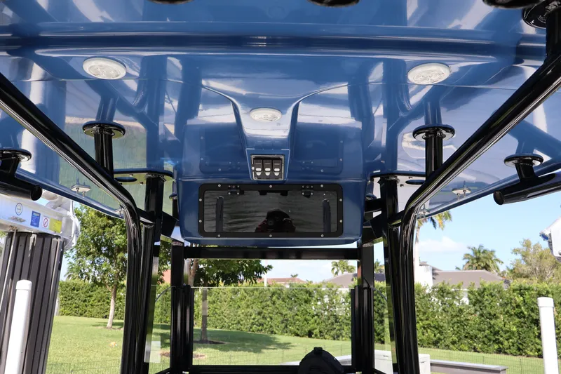 Slide: The Image of 2023 NauticStar 251 Hybrid boat's blue T-top with integrated lighting and controls. - 34