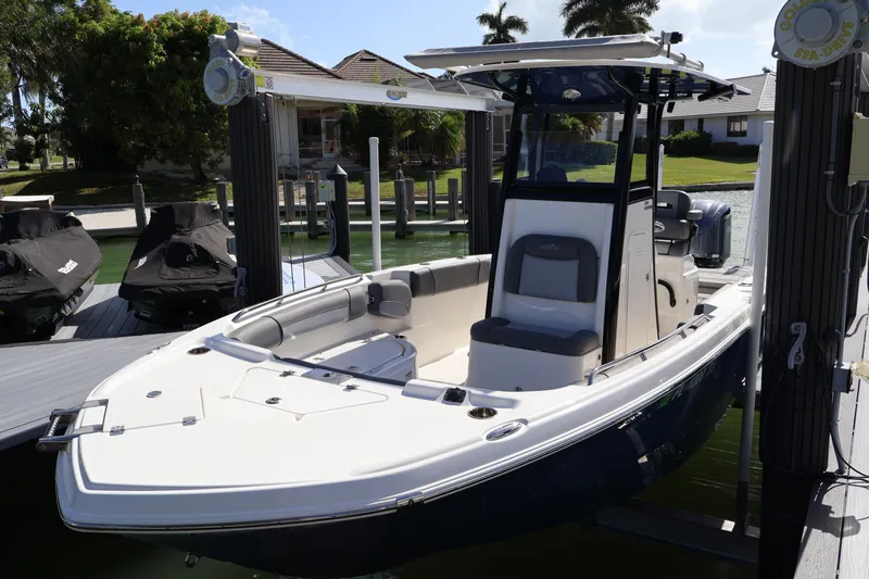 Slide: The Image of 2023 NauticStar 251 Hybrid boat docked, showcasing sleek design and spacious seating. - 37