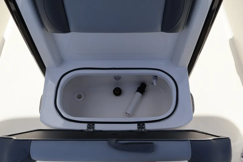 Slide: The Image of 2023 NauticStar 251 Hybrid boat storage compartment with open lid, showcasing interior features. - 17