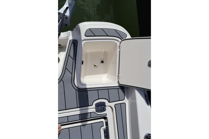 Slide: The Image of 2023 NauticStar 251 Hybrid boat deck with open storage compartment. - 25