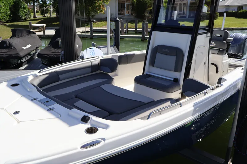Slide: The Image of 2023 NauticStar 251 Hybrid boat with spacious seating and sleek design at a dock. - 43