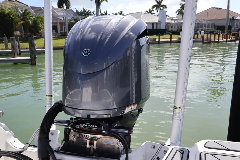 Slide: The Image of 2023 NauticStar 251 Hybrid boat with Yamaha outboard motor docked by waterfront homes. - 22
