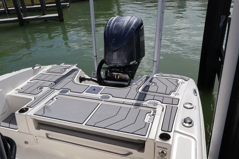 Slide: The Image of 2023 NauticStar 251 Hybrid boat with Yamaha outboard engine, docked on calm water. - 19