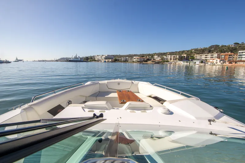 Slide: The Image of 2020 Cruisers Sport Series 338 Bow Rider on calm waters near coastal buildings. - 28