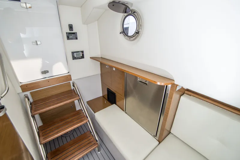 Slide: The Image of Interior of 2020 Cruisers Sport Series 338 Bow Rider, featuring wooden steps and seating. - 33