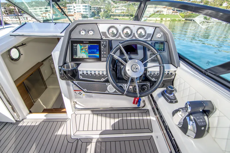 Slide: The Image of 2020 Cruisers Sport Series 338 Bow Rider helm with modern controls and navigation system. - 19