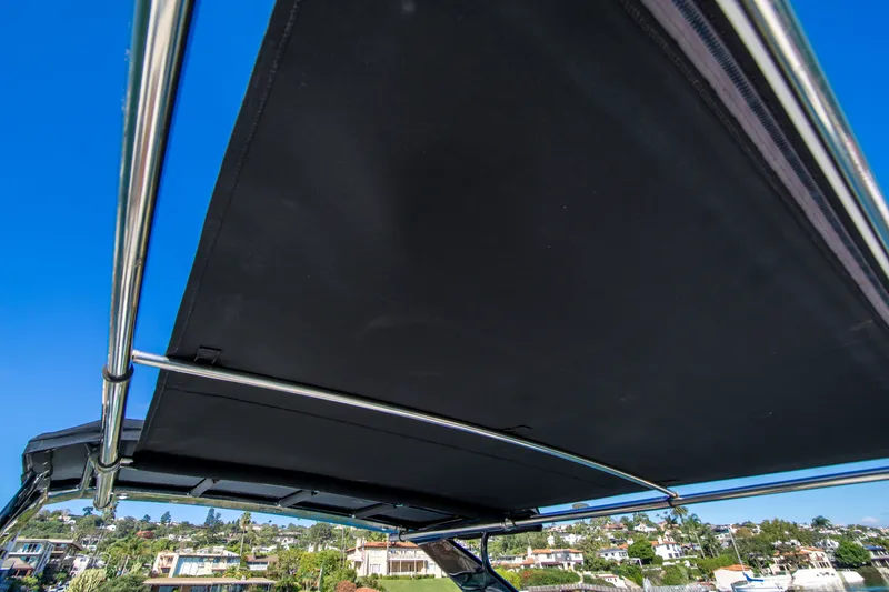 Slide: The Image of 2020 Cruisers Sport Series 338 Bow Rider canopy against clear blue sky. - 22