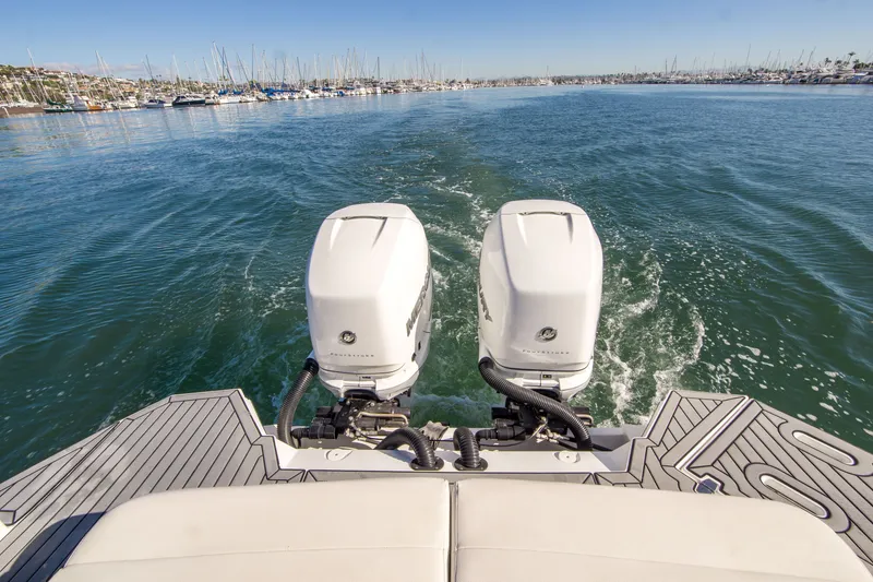 Slide: The Image of 2020 Cruisers Sport Series 338 Bow Rider with dual outboard motors on open water. - 9