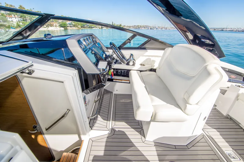 Slide: The Image of 2020 Cruisers Sport Series 338 Bow Rider interior with white seating and modern dashboard. - 18