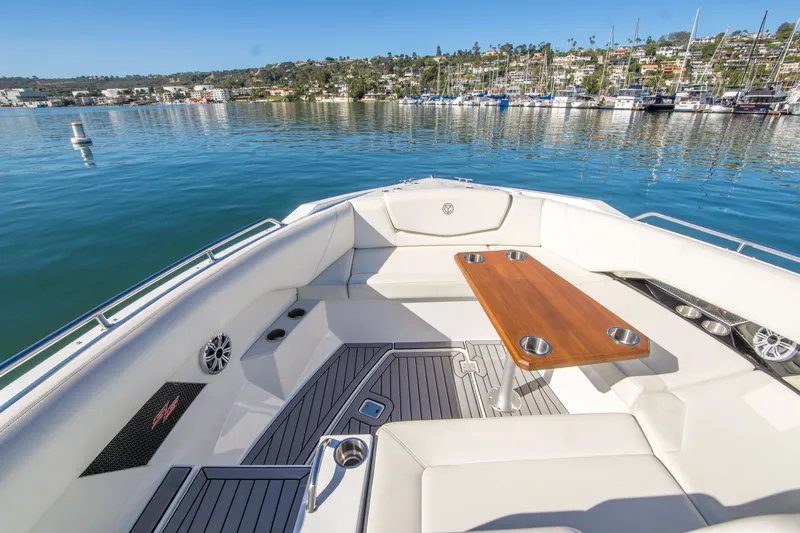 Slide: The Image of 2020 Cruisers Sport Series 338 Bow Rider, luxurious seating and table, scenic marina view. - 30