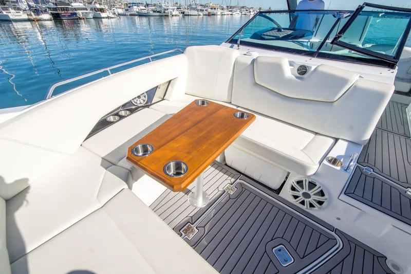Slide: The Image of Luxurious 2020 Cruisers Sport Series 338 Bow Rider with elegant seating and wooden table. - 29