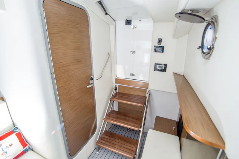 Slide: The Image of Interior of 2020 Cruisers Sport Series 338 Bow Rider, featuring wooden stairs and modern design. - 32