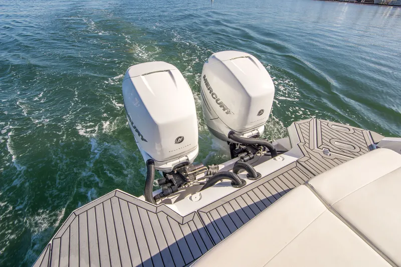 Slide: The Image of 2020 Cruisers Sport Series 338 Bow Rider with dual Mercury outboard engines on water. - 8