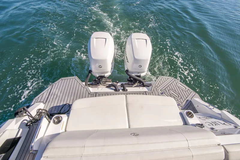 Slide: The Image of 2020 Cruisers Sport Series 338 Bow Rider with dual outboard engines on water. - 7