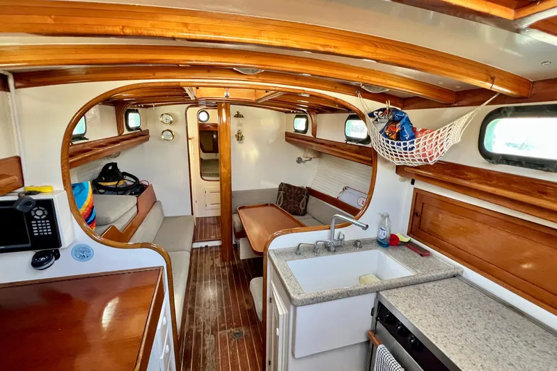 Slide: The Image of Interior of a 1975 Cape George 36 sailboat with wooden accents and compact kitchen. - 41