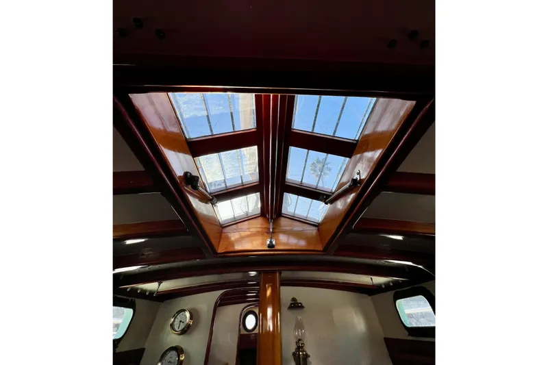 Slide: The Image of Interior view of 1975 Cape George 36 sailboat with wooden skylight and nautical decor. - 60