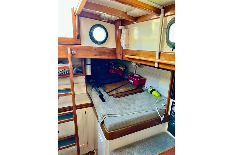 Slide: The Image of Interior of 1975 Cape George 36 sailboat with wooden ladder and cozy berth. - 73