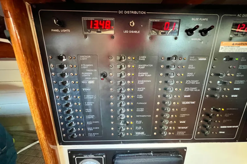 Slide: The Image of Electrical control panel on a 1975 Cape George 36 boat, showing various switches and voltage readings. - 47