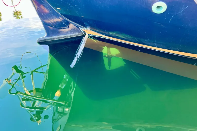 Slide: The Image of Close-up of a 1975 Cape George 36 boat hull and propeller in clear water. - 13