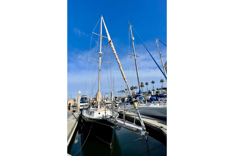 Slide: The Image of 1975 Cape George 36 sailboat docked at marina under clear blue sky. - 5