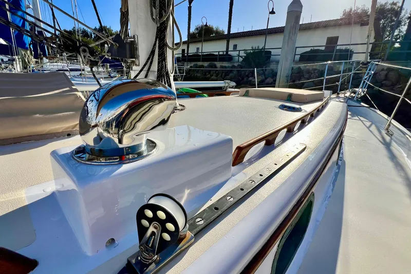 Slide: The Image of 1975 Cape George 36 sailboat deck with polished chrome fittings and wooden accents. - 23