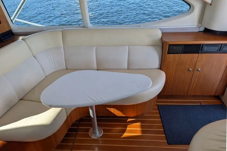 Slide: The Image of Interior of 2006 Tiara Yachts 3900 Convertible with cream seating and wooden cabinetry. - 32