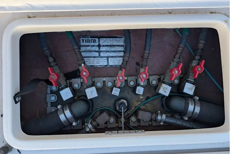 Slide: The Image of Engine compartment of a 2006 Tiara Yachts 3900 Convertible with visible valves and hoses. - 38