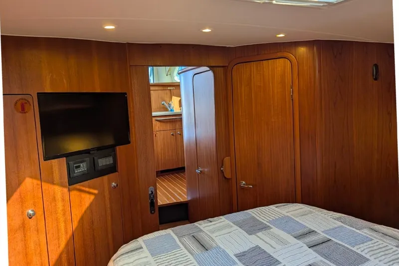 Slide: The Image of Interior of 2006 Tiara Yachts 3900 Convertible with wood paneling and mounted TV. - 24
