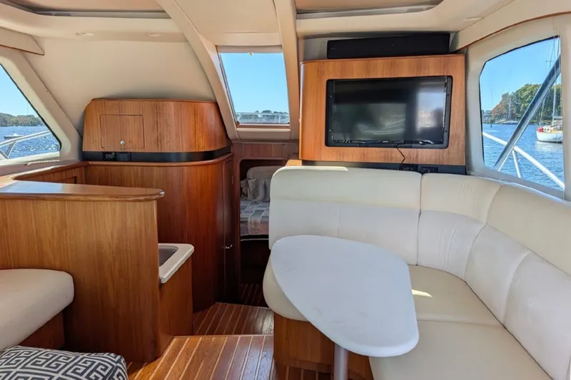 Slide: The Image of Luxurious interior of 2006 Tiara Yachts 3900 Convertible with wood accents and scenic window views. - 29