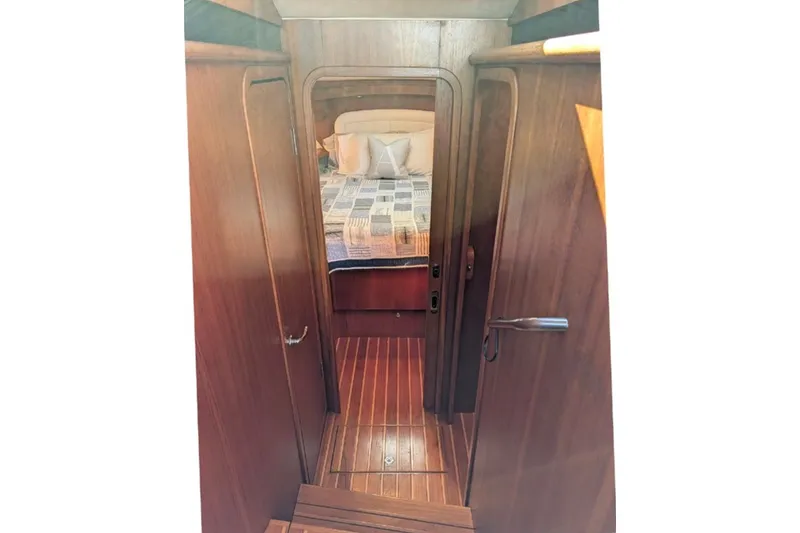 Slide: The Image of Interior view of 2006 Tiara Yachts 3900 Convertible, featuring wooden cabinetry and cozy bedroom. - 26