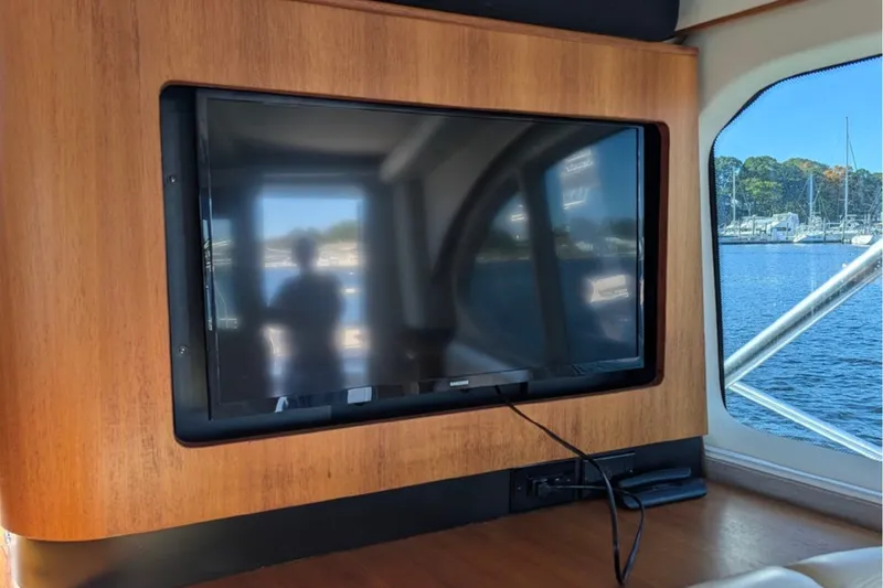 Slide: The Image of Flat-screen TV on 2006 Tiara Yachts 3900 Convertible, with marina view through window. - 31