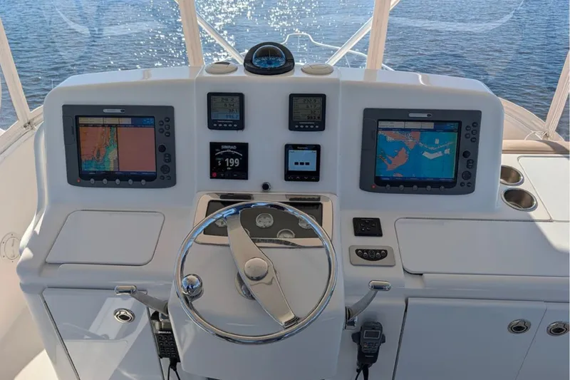 Slide: The Image of Helm of 2006 Tiara Yachts 3900 Convertible with navigation screens and steering wheel. - 16