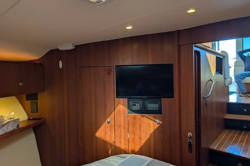 Slide: The Image of Interior of 2006 Tiara Yachts 3900 Convertible with wood paneling and mounted TV. - 23