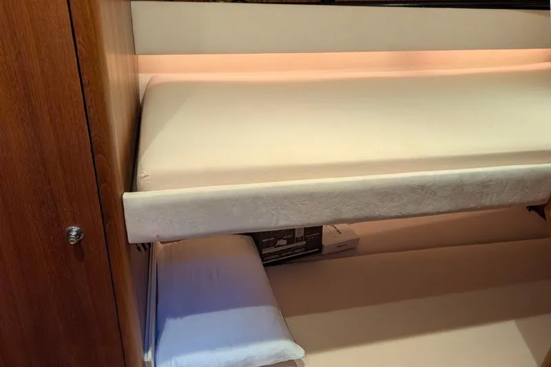Slide: The Image of Interior cabin of 2006 Tiara Yachts 3900 Convertible with bunk beds and wooden cabinetry. - 20