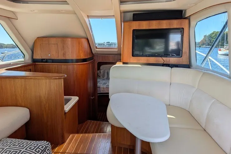 Slide: The Image of Interior of 2006 Tiara Yachts 3900 Convertible with wood accents and white seating. - 34