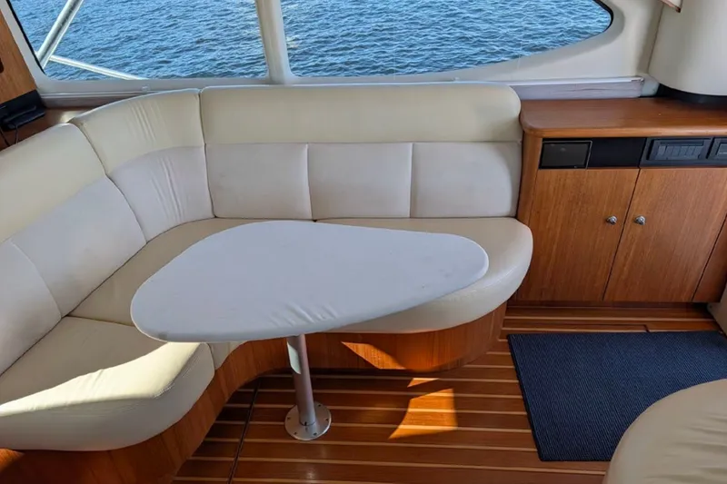 Slide: The Image of Interior of 2006 Tiara Yachts 3900 Convertible with cream seating and wooden cabinetry. - 30