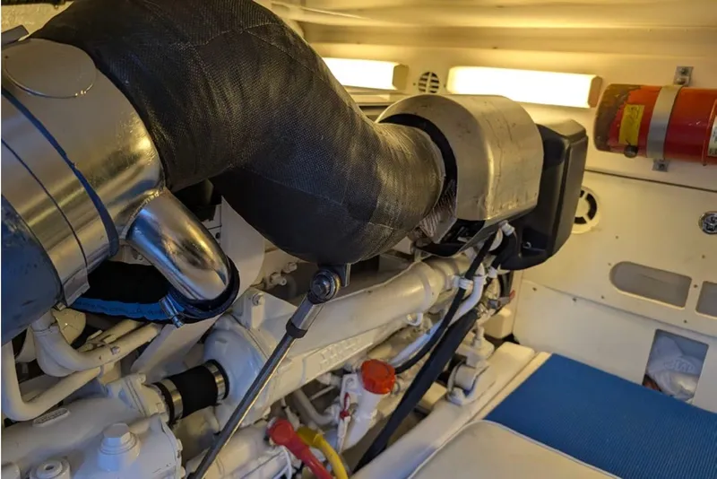 Slide: The Image of Engine room of 2006 Tiara Yachts 3900 Convertible, showcasing mechanical components and fire extinguisher. - 37