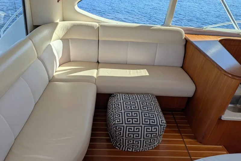 Slide: The Image of Luxurious interior of 2006 Tiara Yachts 3900 Convertible with cream seating and patterned ottoman. - 28