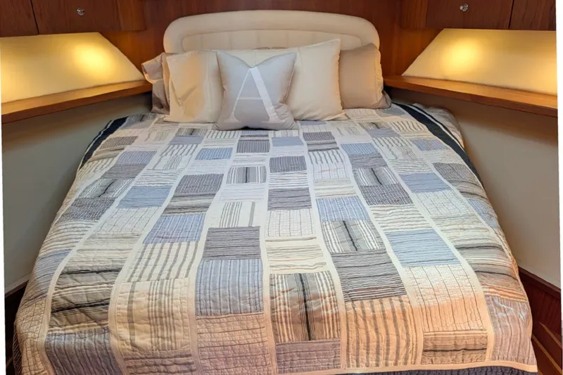 Slide: The Image of Cozy bedroom in 2006 Tiara Yachts 3900 Convertible with patterned quilt and ambient lighting. - 25