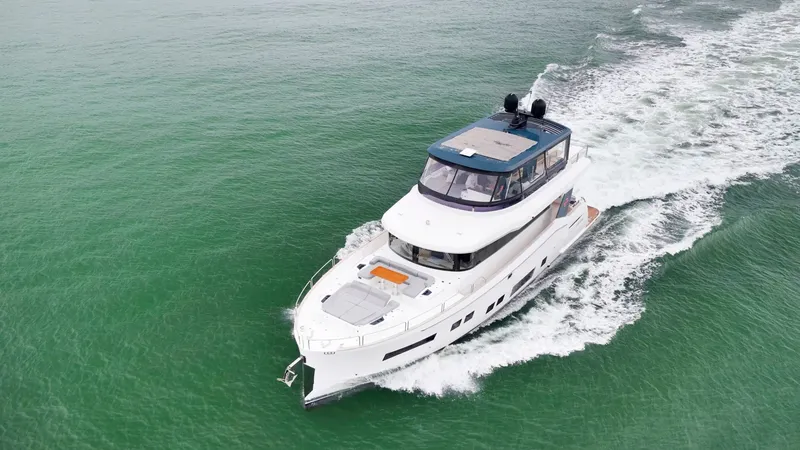 Slide: The Image of A luxurious motor yacht cruises through calm, green waters. It features a modern design and spacious deck. - 5