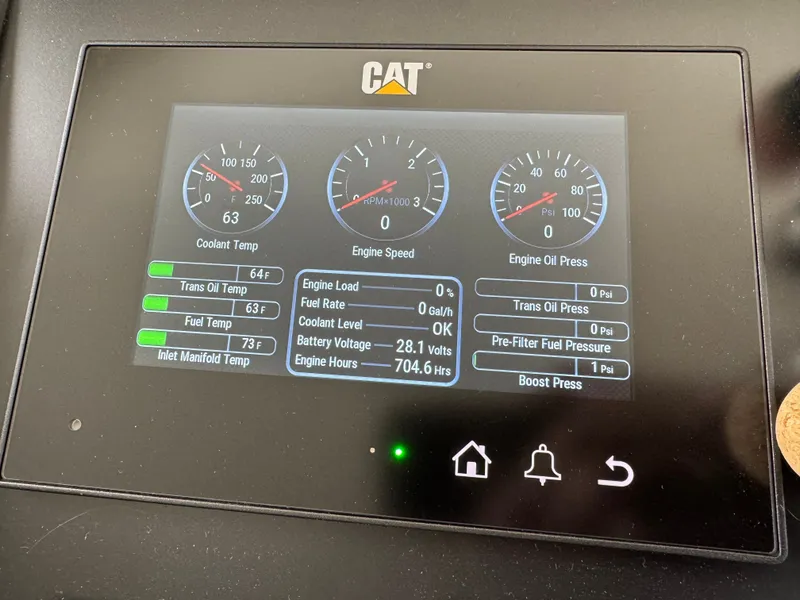 Slide: The Image of A CAT engine control display shows temperature, RPM, and oil pressure. - 34