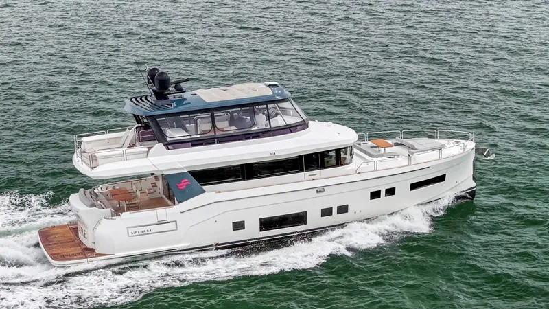 Slide: The Image of The 2020 Sirena 64 cruises on the sea, featuring elegant design and spacious deck. - 8