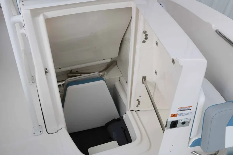 Slide: The Image of The image shows the interior of a Robalo R200 Center Console boat with storage space. - 44